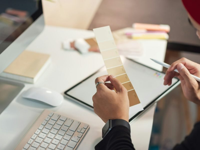 Young man designer choose a palette of brown tones in their office design.